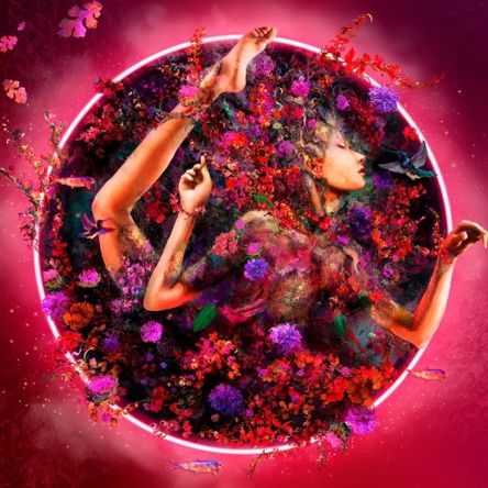 Dreamlike portrait of a woman emerging from a circular burst of colorful flowers and foliage, creating a vibrant surreal composition in pink and red tones.